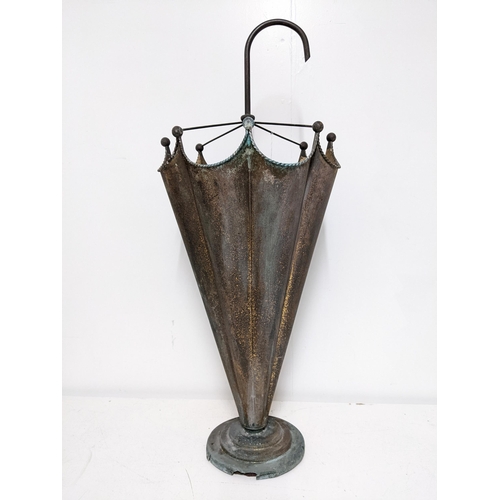 229 - A gilt metal stick stand fashioned as an umbrella, with a curved handle and lobed body, on a stepped... 