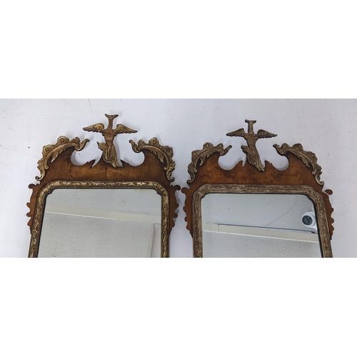 249 - A pair of 20th century Chippendale style parcel-gilt, walnut mirrors surmounted by a bird foliage an... 