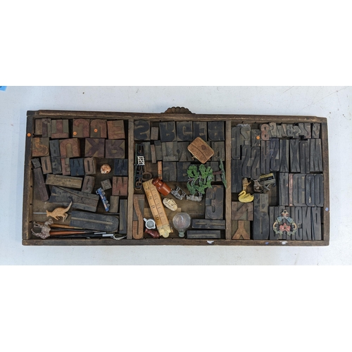 34 - A 19th/20th century printers tray containing a collection of printing blocks, metal model animals, r... 