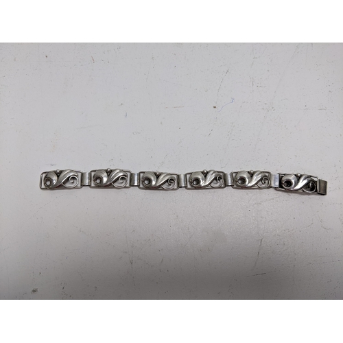 188 - A John Lauritzen Danish silver bracelet, with scrolled floral links, 19.5cm long

Location: CAB 5
If... 