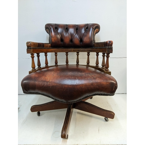 65 - A late 20th century brown leather upholstered and mahogany rotating, height adjustable desk chair

L... 