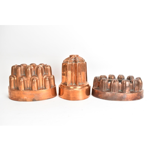 105 - Three 19th century copper jelly moulds, each of castellated form on stepped bases with impressed mar... 