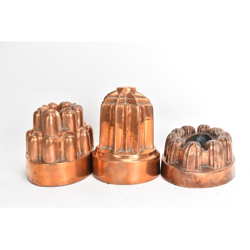 105 - Three 19th century copper jelly moulds, each of castellated form on stepped bases with impressed mar... 