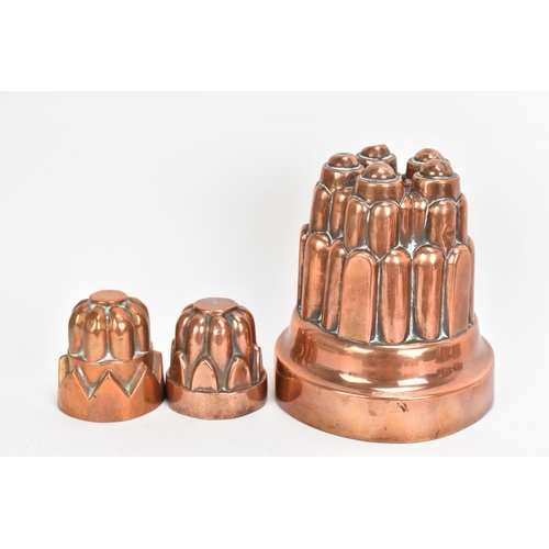 106 - A selection of 19th century copper moulds to include one of circular gadrooned form, another of cast... 