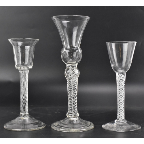 108 - Three mid 18th century drinking glasses, each with an air twist stem, to include one with a bell sha... 