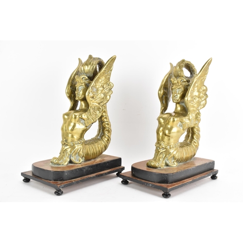 109 - A pair of late 19th/early 20th century cast gilt metal models of sphinxes fashioned as bookends, eac... 