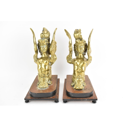 109 - A pair of late 19th/early 20th century cast gilt metal models of sphinxes fashioned as bookends, eac... 