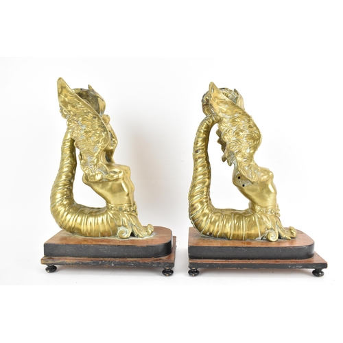 109 - A pair of late 19th/early 20th century cast gilt metal models of sphinxes fashioned as bookends, eac... 