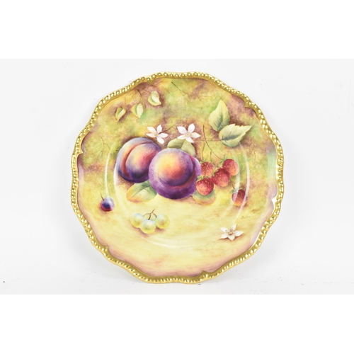 121 - A Royal Worcester fruit decorated cabinet plate, of shaped circular form, hand painted with still li... 