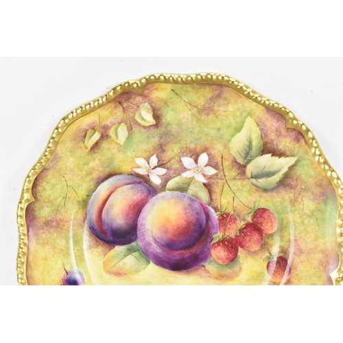 121 - A Royal Worcester fruit decorated cabinet plate, of shaped circular form, hand painted with still li... 