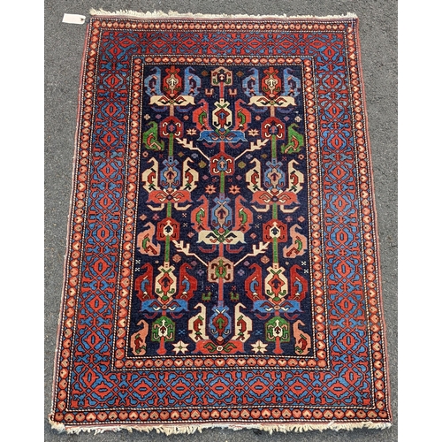 127 - An Erivan central Armenia rug, having an indigo field with rows of polychrome guls within a pale blu... 