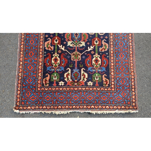 127 - An Erivan central Armenia rug, having an indigo field with rows of polychrome guls within a pale blu... 