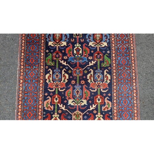 127 - An Erivan central Armenia rug, having an indigo field with rows of polychrome guls within a pale blu... 