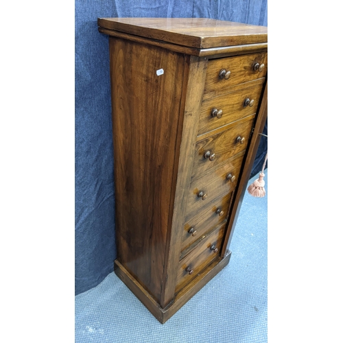 133 - A Victorian walnut wellington chest, having six graduated drawers with bun shaped handles, two side ... 