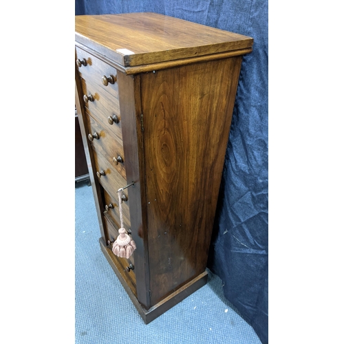 133 - A Victorian walnut wellington chest, having six graduated drawers with bun shaped handles, two side ... 