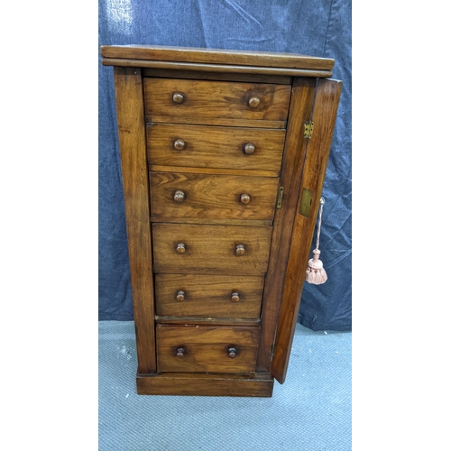 133 - A Victorian walnut wellington chest, having six graduated drawers with bun shaped handles, two side ... 