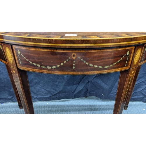 134 - A George III mahogany and satinwood crossbanded marquetry inlaid demi-lune fold-over card table, in ... 