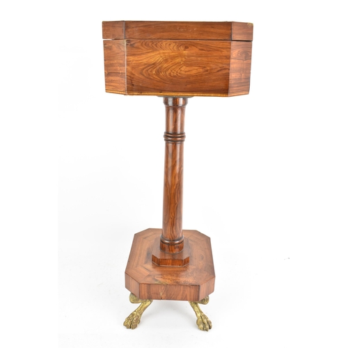 135 - A Regency rosewood teapoy, the octagonal top having satinwood inlaid banding, a two canister fitted ... 