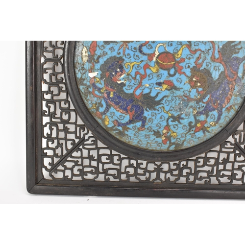 18 - A 19th Chinese cloisonne panel and mirror, housed in an ebonised pierced frame with, the panel havin... 