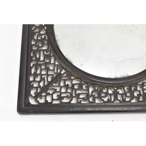 18 - A 19th Chinese cloisonne panel and mirror, housed in an ebonised pierced frame with, the panel havin... 