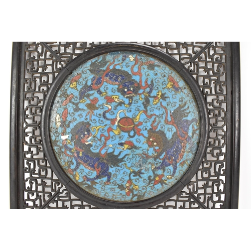 18 - A 19th Chinese cloisonne panel and mirror, housed in an ebonised pierced frame with, the panel havin... 