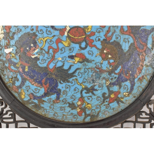 18 - A 19th Chinese cloisonne panel and mirror, housed in an ebonised pierced frame with, the panel havin... 