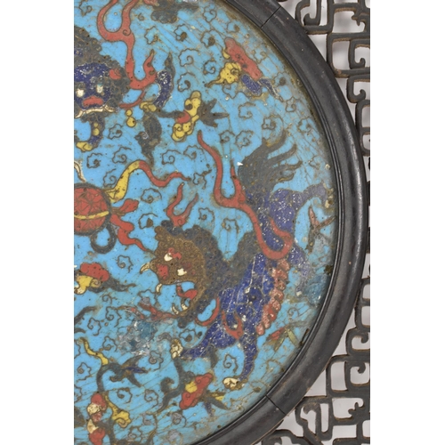 18 - A 19th Chinese cloisonne panel and mirror, housed in an ebonised pierced frame with, the panel havin... 