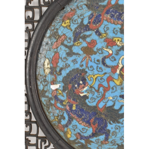 18 - A 19th Chinese cloisonne panel and mirror, housed in an ebonised pierced frame with, the panel havin... 