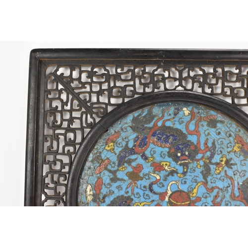 18 - A 19th Chinese cloisonne panel and mirror, housed in an ebonised pierced frame with, the panel havin... 