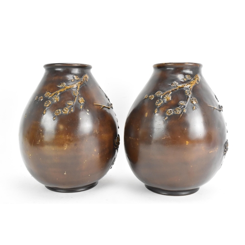 19 - A pair of early 20th century Japanese bronze vases, each of ovoid form and cast relief decoration de... 