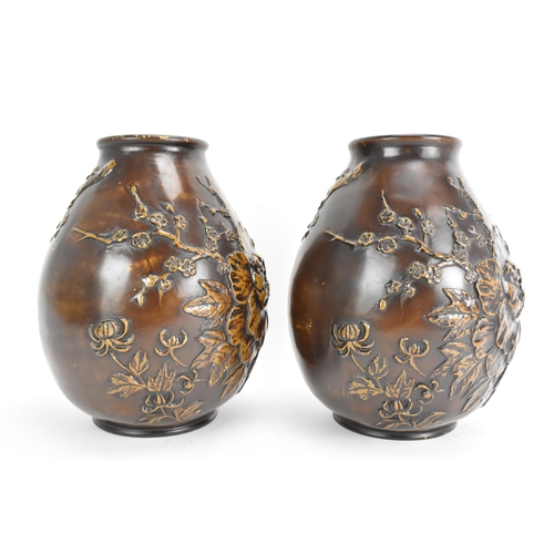 19 - A pair of early 20th century Japanese bronze vases, each of ovoid form and cast relief decoration de... 