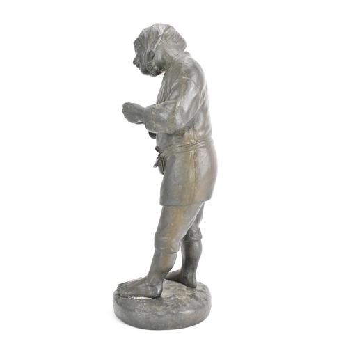 20 - A Japanese Meiji period cast iron figure depicting a gent holding a pipe and standing on a naturalis... 