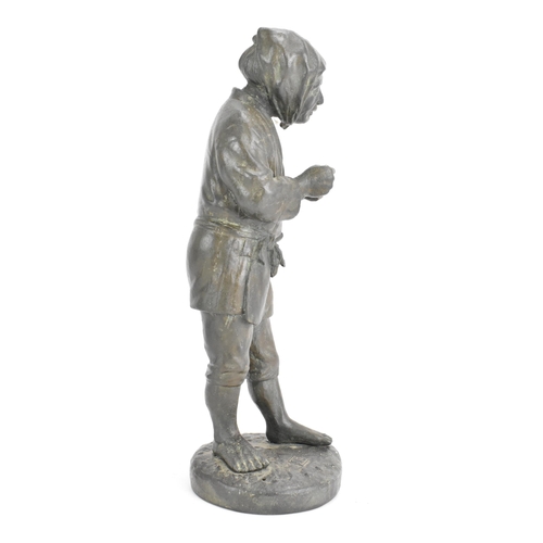 20 - A Japanese Meiji period cast iron figure depicting a gent holding a pipe and standing on a naturalis... 