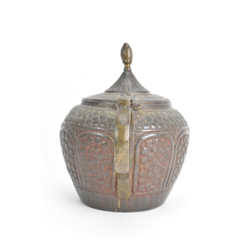 21 - A 19th century Indian Kashmiri copper teapot, profusely decorated with incised and embossed floral d... 