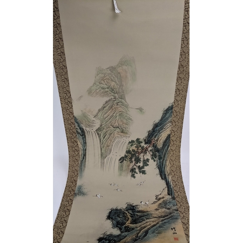 24 - Three 20th century Chinese scroll paintings to include one depicting cranes in a mountain landscape ... 