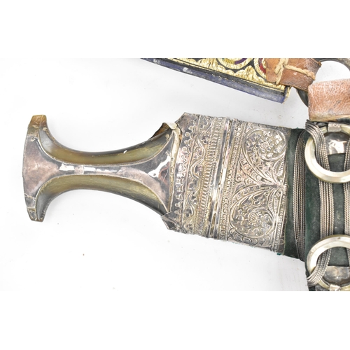 29 - An early 20th century Saudi Omani Jambiya Khanjar dagger, having a horn handle and profusely decorat... 