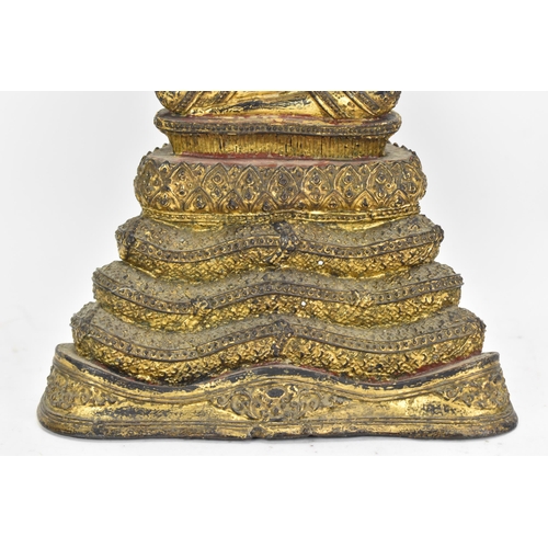 48 - A 19th century Thai gilt bronze Buddha, Cast seated in meditation on a coiled snake, his hands held ... 