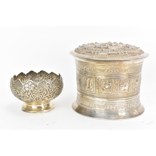 50 - A late 19th/early 20th century Burmese white metal betel box, embossed and incised with panels of fi... 