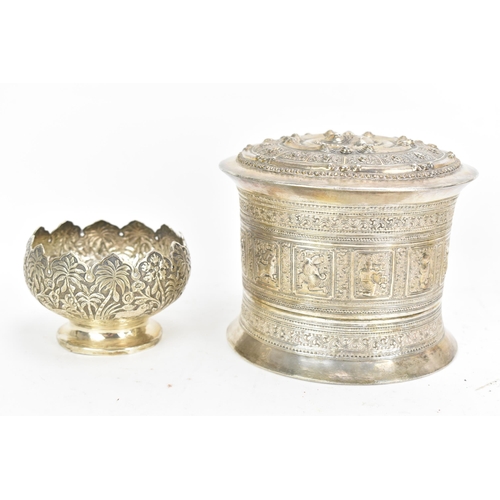 50 - A late 19th/early 20th century Burmese white metal betel box, embossed and incised with panels of fi... 