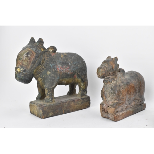 51 - Four 19th/20th century Indian carved models of Nandi/bulls, the largest in a standing pose with pain... 