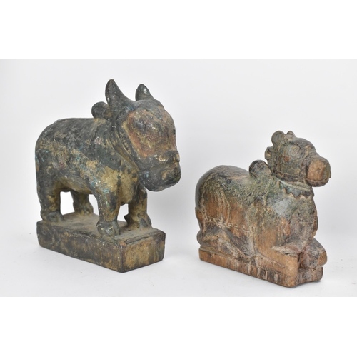 51 - Four 19th/20th century Indian carved models of Nandi/bulls, the largest in a standing pose with pain... 