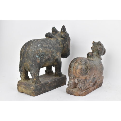 51 - Four 19th/20th century Indian carved models of Nandi/bulls, the largest in a standing pose with pain... 