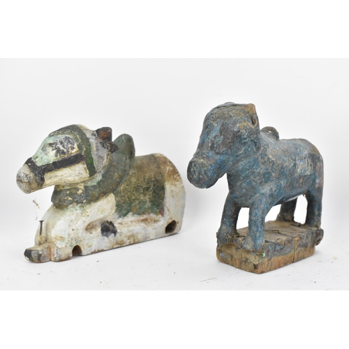 51 - Four 19th/20th century Indian carved models of Nandi/bulls, the largest in a standing pose with pain... 