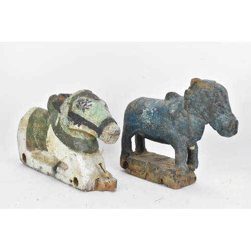 51 - Four 19th/20th century Indian carved models of Nandi/bulls, the largest in a standing pose with pain... 