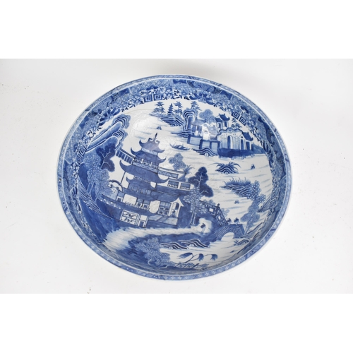 56 - A Chinese export Qing dynasty blue and white punch bowl, late 18th century, the interior painted wit... 