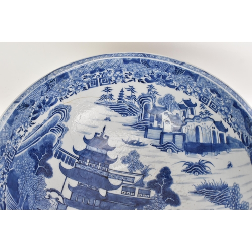 56 - A Chinese export Qing dynasty blue and white punch bowl, late 18th century, the interior painted wit... 