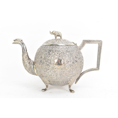 58 - A late 19th/early 20th century Indian white metal three piece tea service, consisting of a teapot, s... 