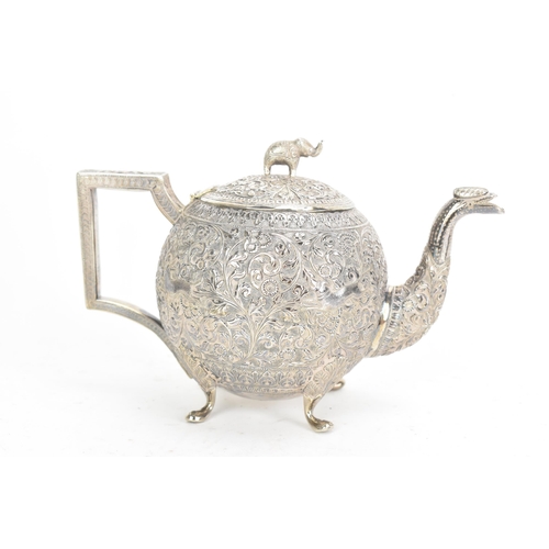 58 - A late 19th/early 20th century Indian white metal three piece tea service, consisting of a teapot, s... 