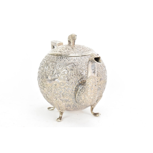 58 - A late 19th/early 20th century Indian white metal three piece tea service, consisting of a teapot, s... 