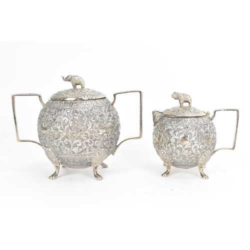 58 - A late 19th/early 20th century Indian white metal three piece tea service, consisting of a teapot, s... 